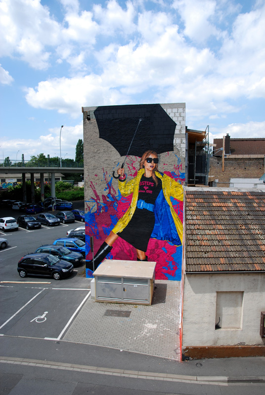 Meeting of Styles 2012 in Mainz-Kastel. Dancing girl with a yellow raincoat and an umbrella in the rain. Painted on two hot days.