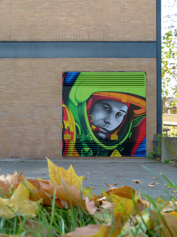 SiveOne and Mr. Flash painted on the subject of technology, research and science a pop art portrait of Juri Gagarin during 11.11.2011. Gagarin was the first cosmonaut of the humanity. He has circuited the earth in space fifty years ago. The graffiti art of 3Steps is to be found on a building at the THM university campus in Giessen.